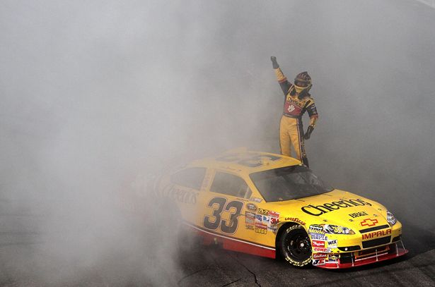 Clint Bowyer celebrates his first win in 88 NASCAR Sprint Cup Series starts by doing a burnout and saluting the fans on Sunday at the New Hampshire Motor Speedway in Loudon, N.H., the first race in the Chase for the NASCAR Sprint Cup. Credit: Gregg Ellman-Pool/Getty Images